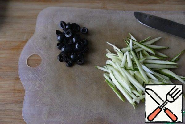 Cucumber cut into strips, olives rings.