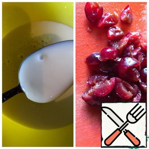 Remove the stone from the cherry and pour in the cognac. Leave for 2 hours. Then drain the brandy, and the cherries cut into small pieces. Put condensed milk, milk and cream in a whipping container. Beat for a minute.
