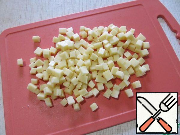 Cut the cheese into cubes.