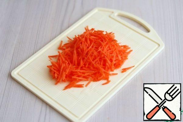 Carrots (1 PC.) on a grater for cooking Korean salads with a small section.