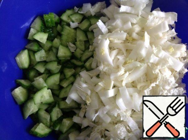 Cut the cucumbers into cubes and chop the cabbage quite finely.