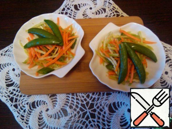 For dressing, mix vinegar with sugar and salt and add oil. Pour the dressing into the salad, mix and serve.
On top for decoration, you can put whole spatulas of peas.