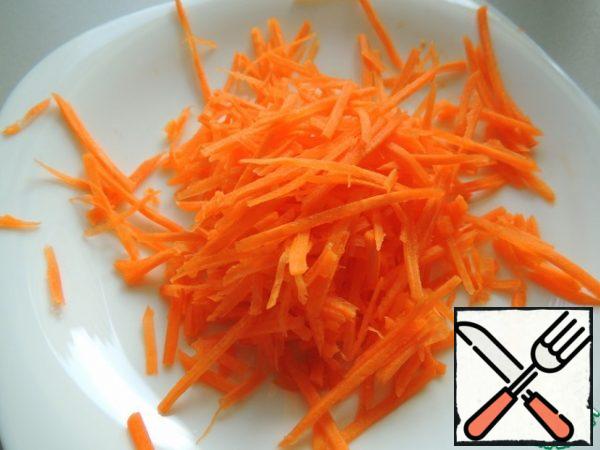 Three carrots on a grater or cut into strips.