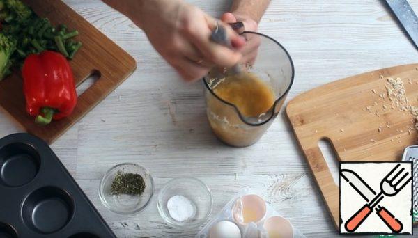 Break the eggs into a jug or bowl and mix with salt and Provencal herbs.