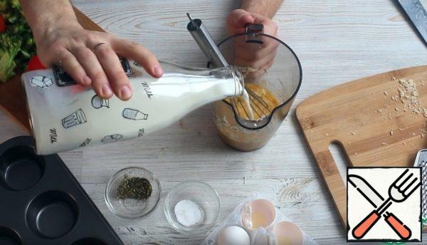Add grated cheese and milk to the egg mixture. Shake well with a whisk.