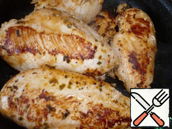 Then preheat a skillet over high heat.  Place the chicken fillet in it, cover and cook until browned, about 5 minutes.