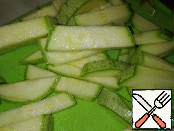 Cut zucchini into strips.
