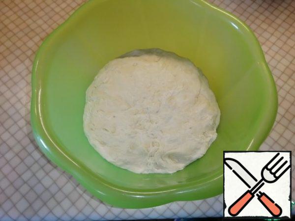 Gradually add the flour and knead the dough. Cover with a towel or cling film and put in a warm place for 1 hour.