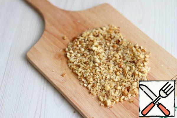 Wash the walnuts and dry them/fry them in a pan without adding oil.