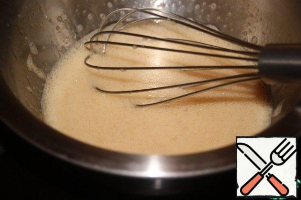 In a large container (I have a frying pan), pour boiling water and place a bowl with the egg mixture in it. Constantly interfering allow it to heat up to 40*C. The sugar will melt.