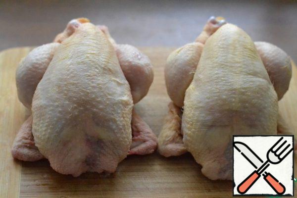 Prepare the chickens. Season with salt and pepper inside and out.