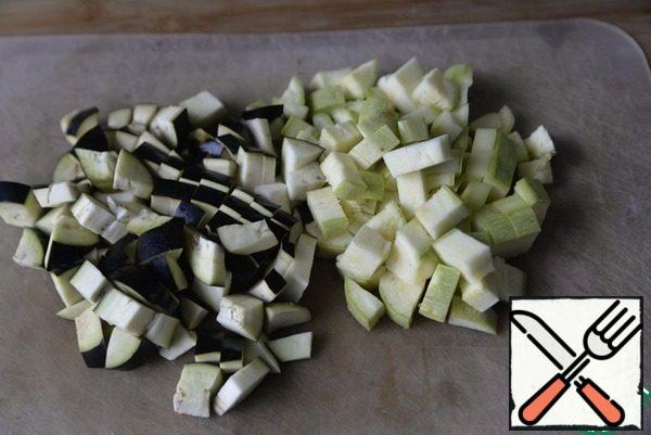 Young zucchini and eggplant cut into cubes. If you are afraid that the eggplant will be bitter, then cut off the skin.