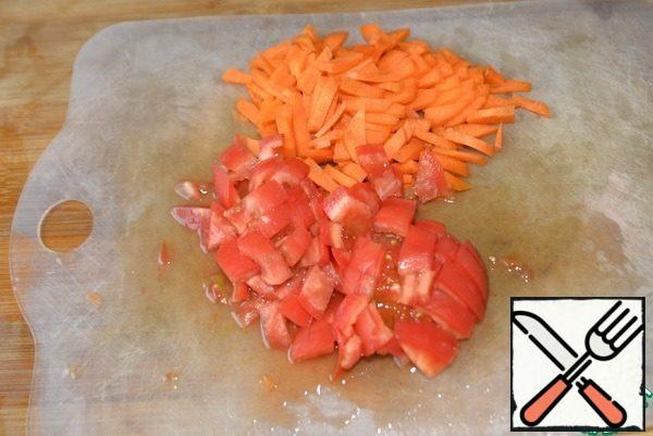 Carrots are cut into small cubes or strips, tomatoes are diced.