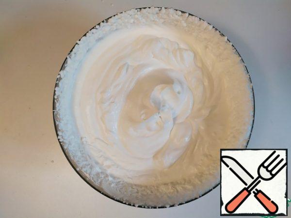 In a separate bowl, beat the cream to stiff peaks.