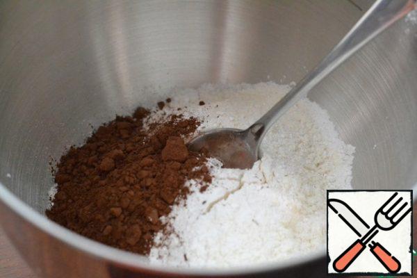In the bowl of a mixer, use a spatula to mix the flour, baking powder, and cocoa powder.