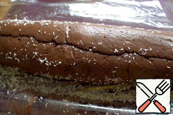 Roll the roll on coconut shavings for decoration. Wrap in the same cling film and put in the refrigerator overnight or freezer for quickness.