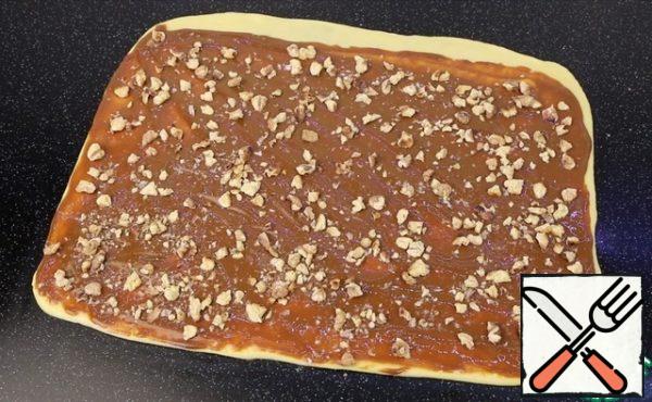 Evenly distribute condensed milk, nuts and salt. I leave a free edge on one side just 1-2 cm to pinch the roll.