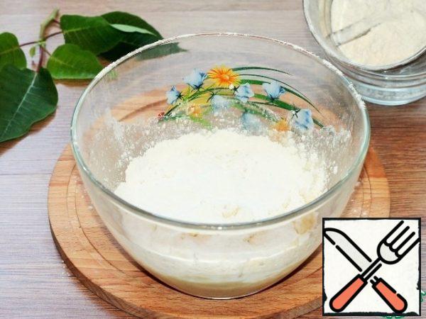 Add the sifted flour and mix until smooth. If the dough is liquid, add a little more flour.