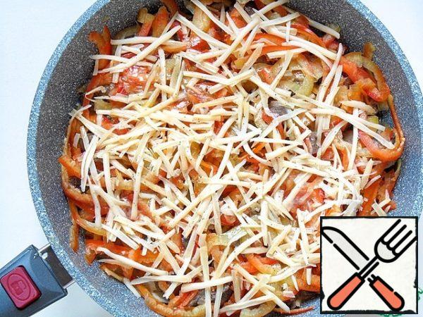 Spread this mixture evenly over the contents of the mold and sprinkle grated cheese on top.