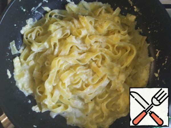 Put the finished fettuccine in a frying pan and stir for literally 1-2 minutes over low heat.  If necessary, add a little fettuccine water to thin the sauce.