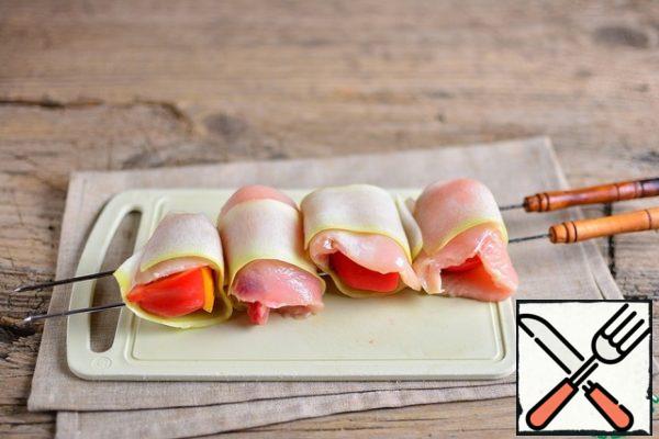 Similarly, twist another 3 rolls and thread on a skewer.