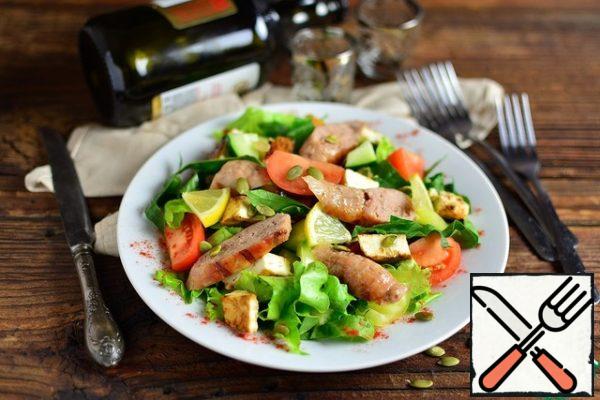 The salad spread cut into cubes cheese, cut into arbitrarily sausages, add the seeds. Add salt and pepper to taste, add a little honey to the oil and season the salad.