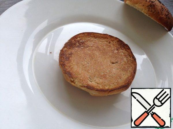 Cut the buns (I have homemade whole grains) in half and dry the bottom part in a non-stick frying pan without oil!  Grease the halves with butter.