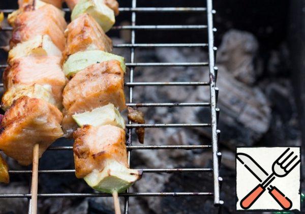 Cook kebabs on low-heat coals on a grill for 3-4 minutes on each side, periodically greasing with a mixture of oil and soy sauce.