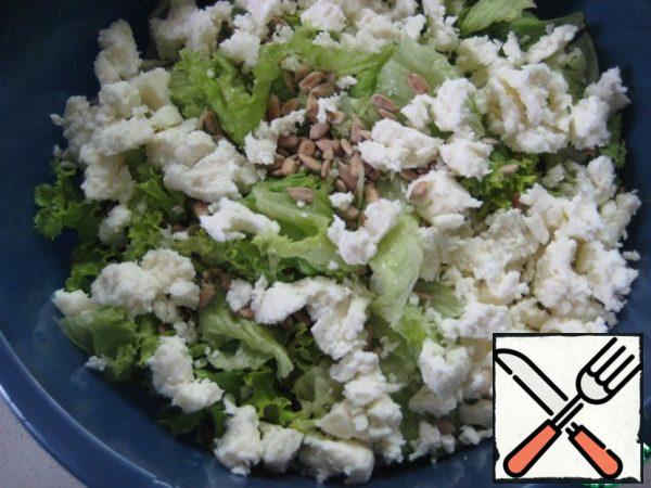 Add sunflower seeds and Adyghe cheese crumbled into small pieces.
Season with salt and pepper to taste.
Mix olive oil and vinegar for dressing.  Season the salad, stir and serve immediately.