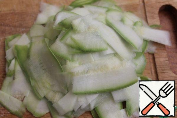 Cut the zucchini as thin as possible (a vegetable peeler is good for this). Salt and leave for half an hour.