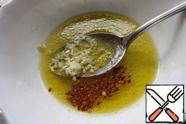 Mix olive oil, water and lemon juice. Add garlic, sesame seeds, salt and pepper to taste.