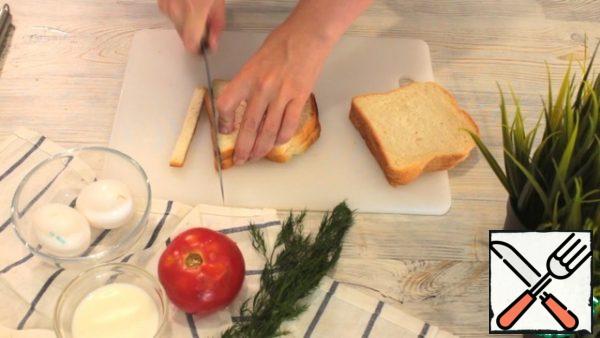 Prepare the bread. Cut the crusts.