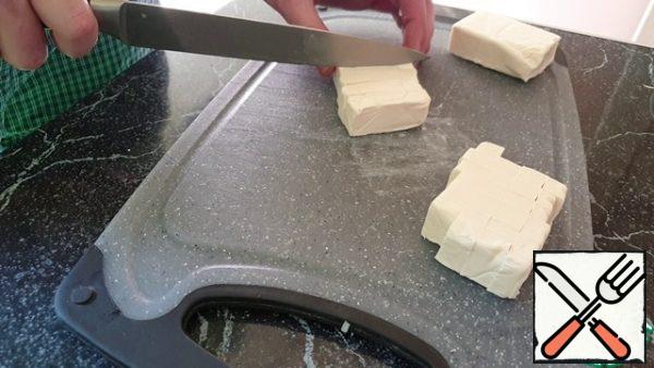 Cut the melted cheese into small cubes.