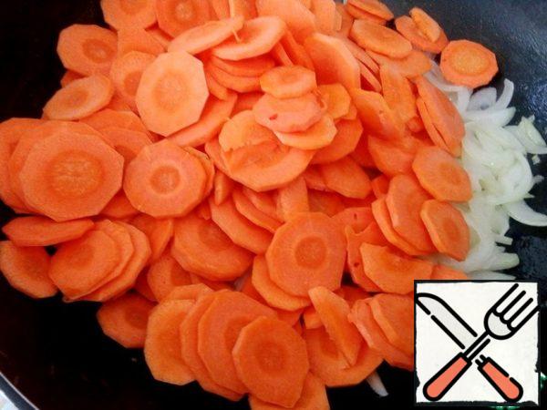 Add carrots to the onion, simmer for five minutes, over medium heat, stirring occasionally.