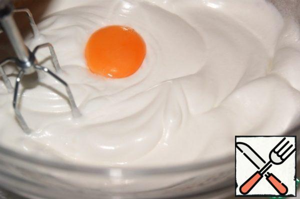 Without ceasing to beat, add the yolks and vanilla one at a time.