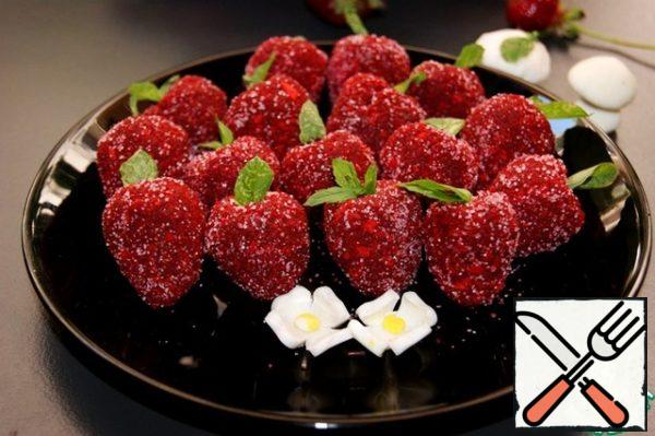 Lightly roll in sugar (I have pink), it will look like strawberry seeds.
Use a toothpick to insert a sprig of mint into each candy.
I also made a couple of strawberry flowers and mushrooms out of mastic.