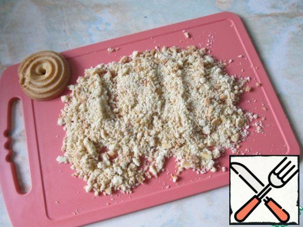 Crumble the cookies, leave one for sprinkling.