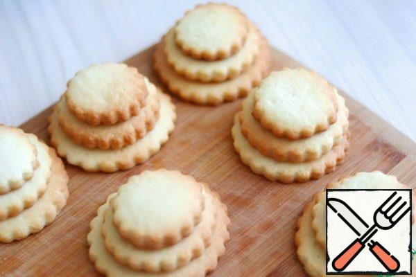 Melt the milk chocolate in a water bath. Then the liquid chocolate is put in a pastry bag and pour prepared chocolate cookies.