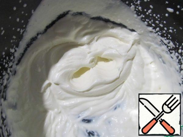 Beat the cream into a strong foam.