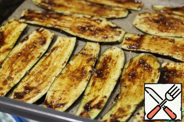Use a brush to apply the marinade to the eggplant slices.