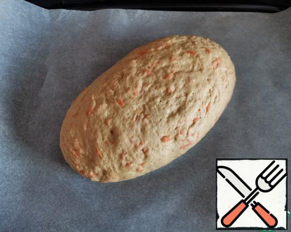Knead the dough, form an oval, place on a baking sheet covered with parchment and leave for 20-30 minutes, covered with a towel.