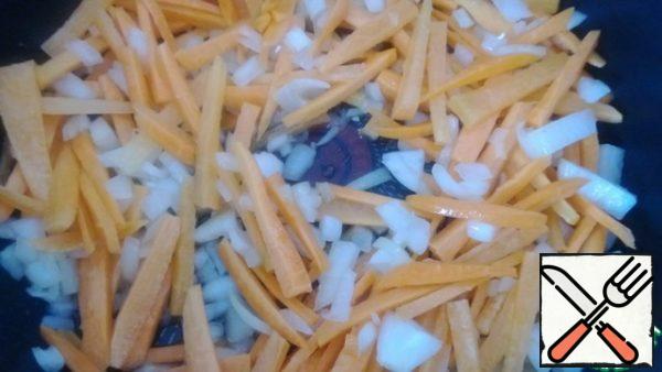 Fry onions and carrots in vegetable oil.