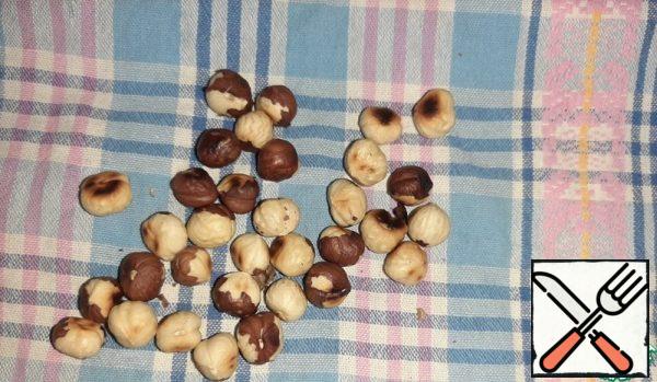 Fry the nuts and peel them.