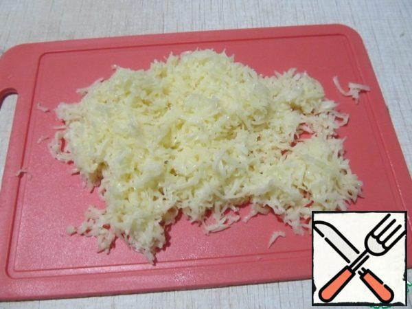 Grate the cheese on a fine grater.