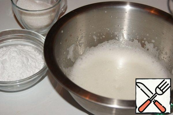 Whisk the whites with a small pinch of citric acid into a fluffy white foam.