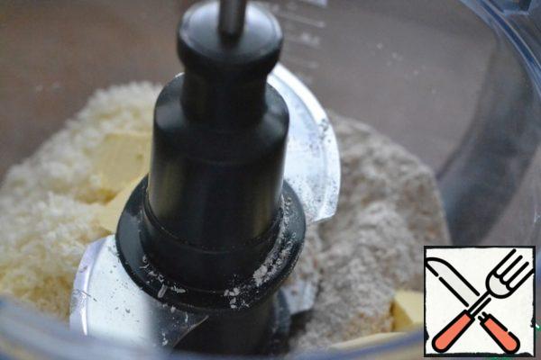 In the bowl of a blender, combine the flour, salt, Parmesan and very cold butter, cut into pieces.