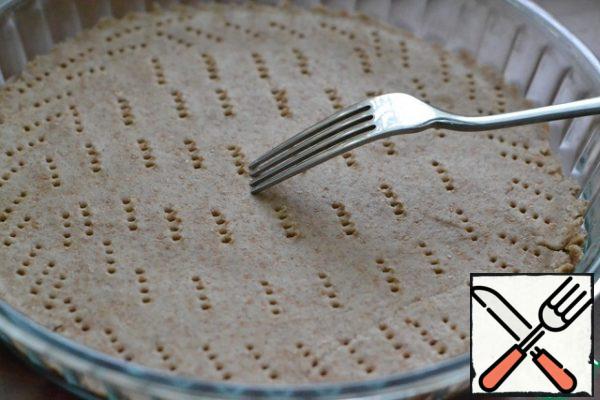 Put the dough on baking paper.
Use a fork to pierce the dough.