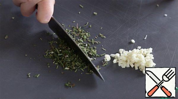 Finely chop the garlic and herbs-rosemary and thyme.