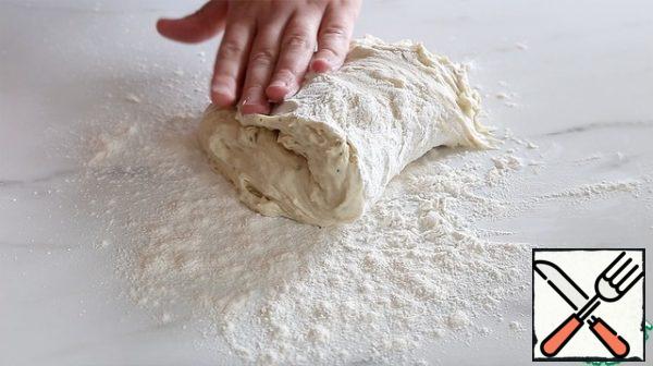 Sprinkle the table with flour, lay out and knead the dough, it should be very light and soft, not sticky, but not tight at all.