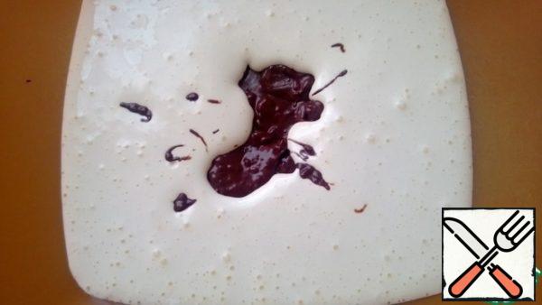 Using a spatula, gently mix the yolks with the cooled chocolate and butter.